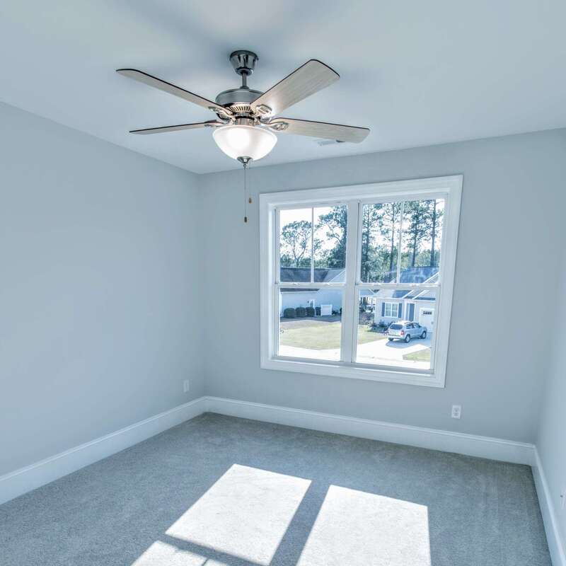 bedroom with ceiling fan, double window, and carpet
