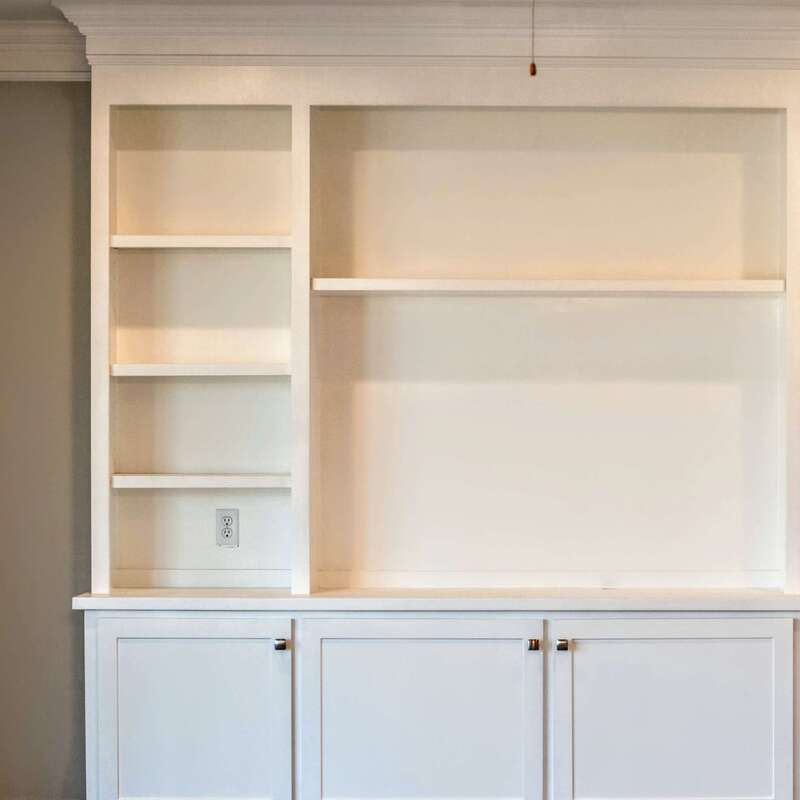 detailed image of white built-in bookshelf and entertainment center with cabinets