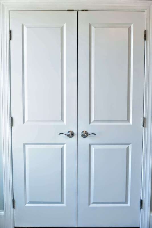 detailed french doors to closet with lever handles