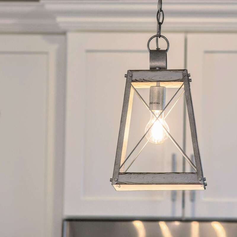 kitchen chandelier-style single bulb drop lights detail alternate view with white kitchen cabinets in background